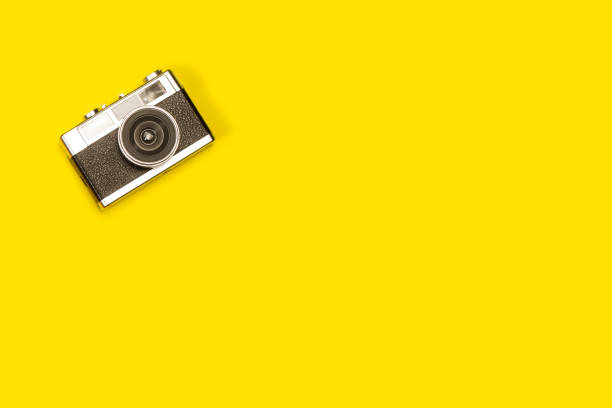 istock Vintage photographic camera on a yellow background 1401568922