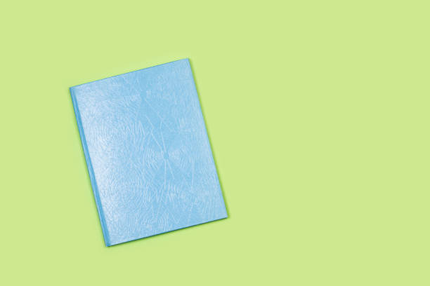 istock A blue cover closed book on a green background 1401568971