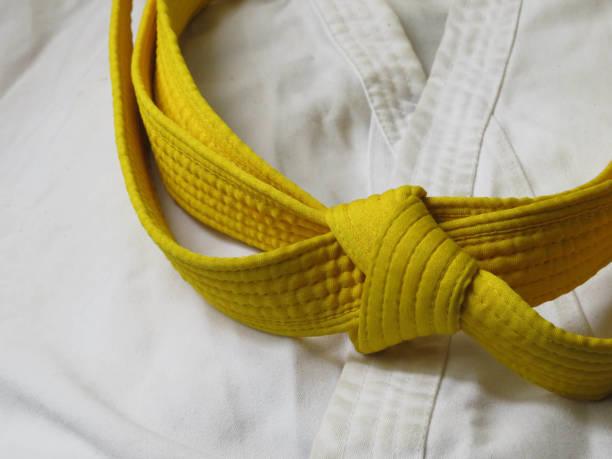 istock Martial arts uniform with yellow belt 1401571366