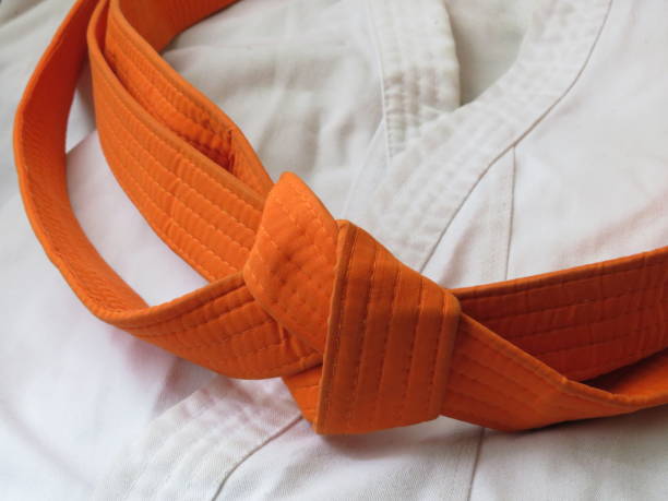 istock Martial arts uniform with orange belt 1401571369
