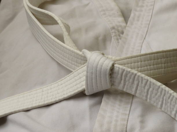istock Martial arts uniform with white belt 1401571370