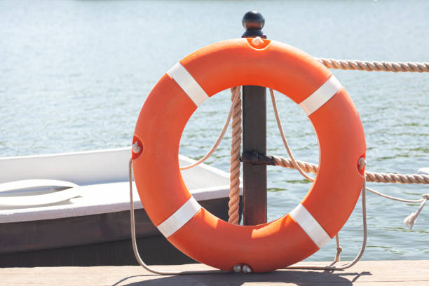 pier with lifebuoy and boat. boats for walking. boats rental. relax in the summer - buoy horizontal lake sailing imagens e fotografias de stock