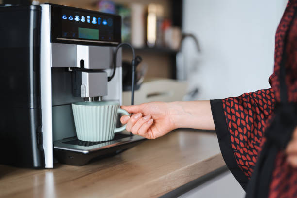 istock Woman use coffee machine to make coffee 1401574571
