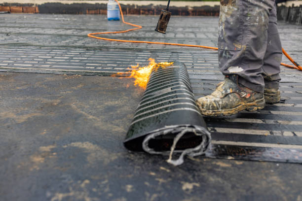 istock Workers placing a vapor barrier on the roof using a propane gas torch for welding bitumen sheets 1401575366