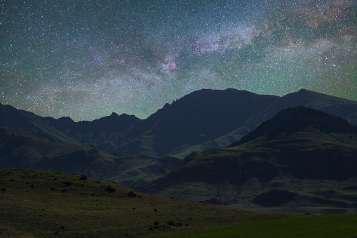 Beautiful night landscape, milky way galaxy mountains and hills.