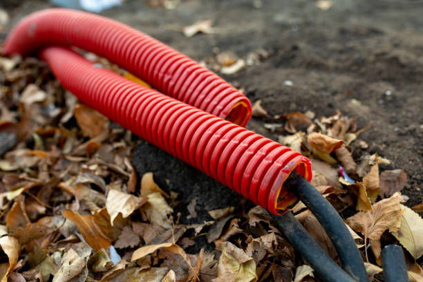 istock Large red plastic corrugated pipes with wires for connecting lighting on the construction site 1401578337