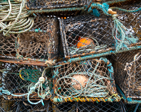 A pile of old and much-used crab pots on a Suffolk quayside.