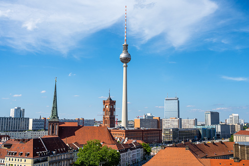 The famous TV Tower of Berlin with the town hall on a sunny day