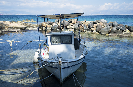 white Greek fishing boats on the sea pier