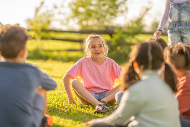 istock Children Sitting Outside Together 1401581969