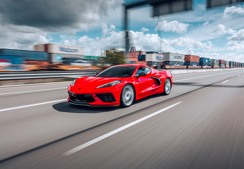 Seattle, WA, USA
4/13/2022
Red Corvette C8 driving on the highway with no cars around