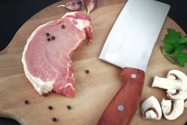 Tenderloin fillet mignon on kitchen cutting board with ingredients for cooking