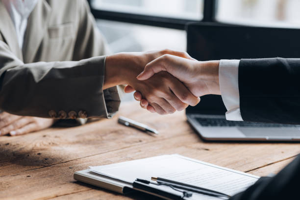 istock Managers and job applicants shake hands after the interview, resumes are important documents for job application. It should contain resume, training history, education, talent, work skills, etc. 1401585417