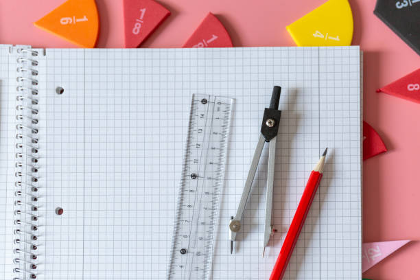 istock Geometry Set on open notebook.  Compass Drawing Tool, ruler, pencils, multicolored fractions for mathematical education. Math Drafting Dividers Tool, set for school, study. Back to school concept 1401586825