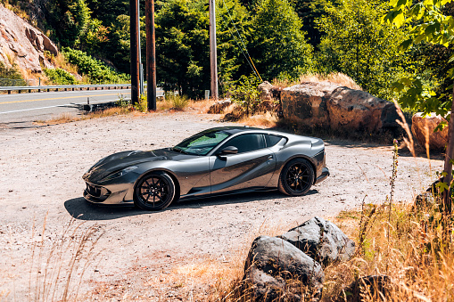 Greenwater, WA, USA\n2/12/2022\nFerrari 812 parked on gravel with large rocks in the background