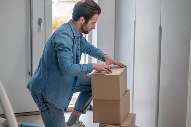 istock Man sideways to camera crouched near boxes 1401587395