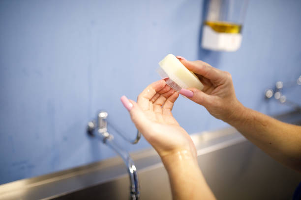 istock Doctor cleansing hand with surgical scrub brush 1401589718