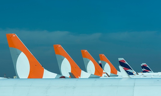 São Paulo, Brazil: May 24, 2022: Partial view of several Gol Airlines and Latam Airlines planes lined up. Vertical stabilizers and rudder. Congonhas Airport.