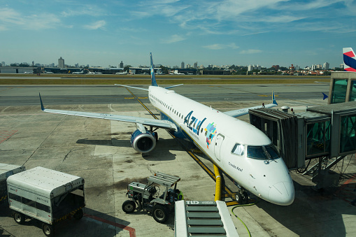 British Airways Jumbo Jet connected to jetway and service modules at a stand in Terminal 5 of Heathrow Airport, London, UK.