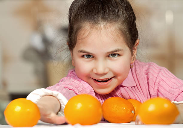 istock Cute little girl with orange 140159154