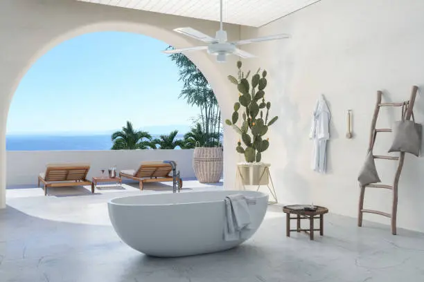 Modern Bathroom With Bathtub, Cactus Plant And Wooden Ladder. Deck Chairs In The Balcony With Seaview Background.