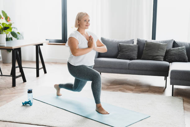 istock Young caucasian plus size plump athlete woman training, doing slimming shaping exercises on fitness mat at home, meditating, practicing yoga 1401592396