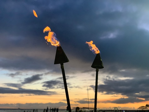 2 Gas torches in front of an Hawaiian sunset