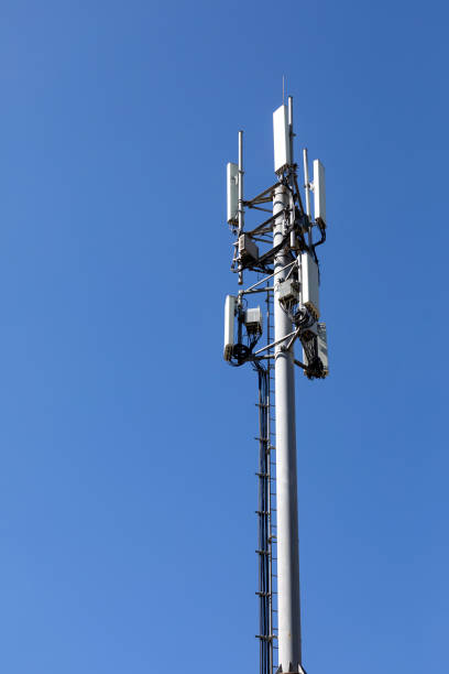 istock Telecommunications tower with 4G, 5G transmitters. cellular base station with transmitting antennas on a telecommunications tower against the blue sky 1401593646