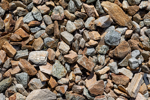 Gravel texture or stone background for design for design on the construction theme. Real fine-grained stones