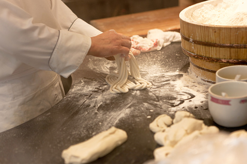 Close-up of chef making fresh noodles from scratch