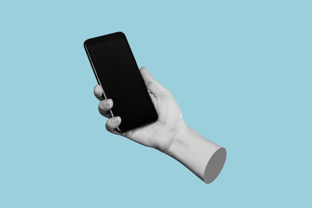 Mobile phone with black screen in female hand isolated on a blue color background. Contemporary art Mobile phone with black screen in female hand isolated on a blue color background. Blank with an empty copy space for the text. Trendy collage in magazine urban style. Contemporary art. Modern design mobile sculpture stock pictures, royalty-free photos & images