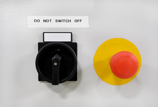 A button and a switch next to a sign reading \