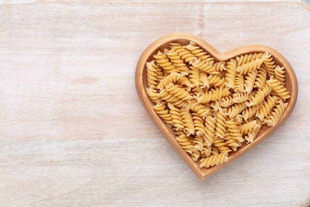 Pasta in a heart shaped bowl.