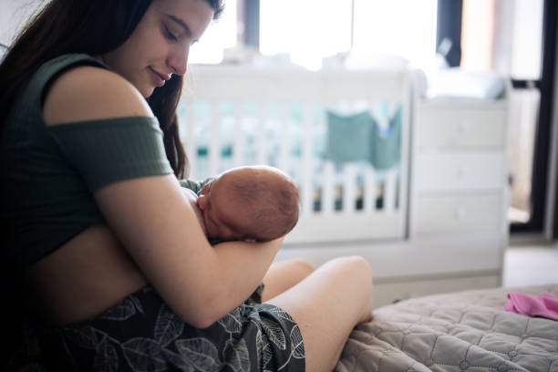 istock Young mother breastfeeding her baby. 1401599451