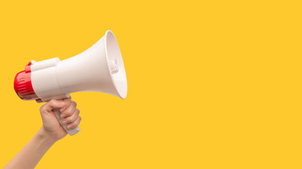 istock Megaphone in woman hands on a white background. 1401599514