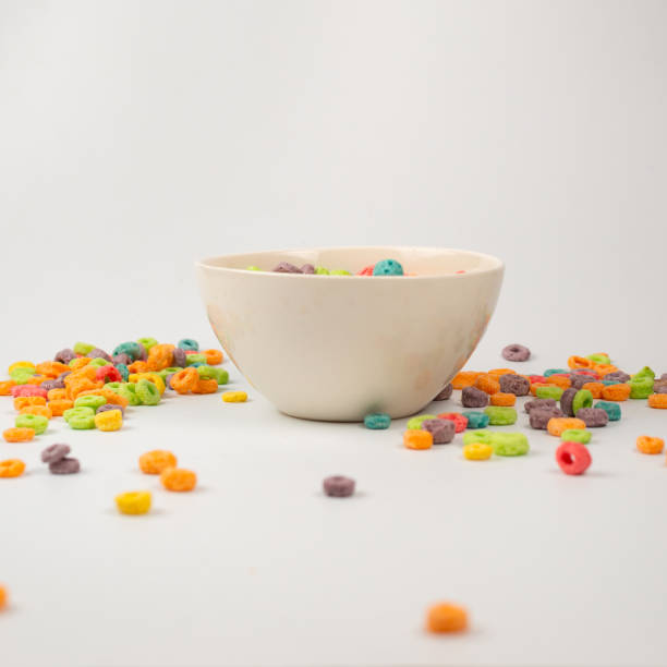 istock Colorful cereal box for morning breakfast. Corn flakes falling to the white bowl. Motion. 1401599559