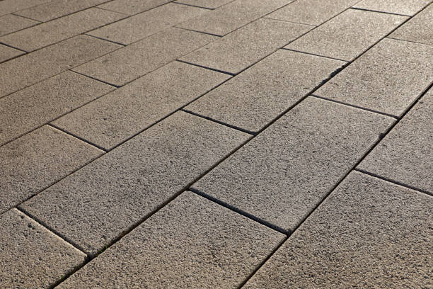 istock Stone pavement texture, cobbled street in sunlight 1401600348