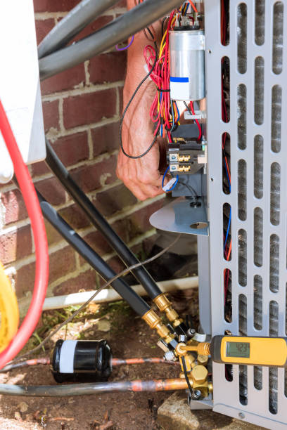 istock Professional man is fixing a unit of central air conditioning system 1401600528