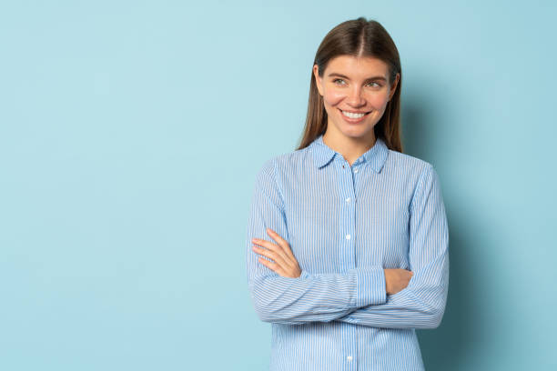 istock Pretty pensive smart confident girl standing with arms folded over blue background with copy space 1401601723