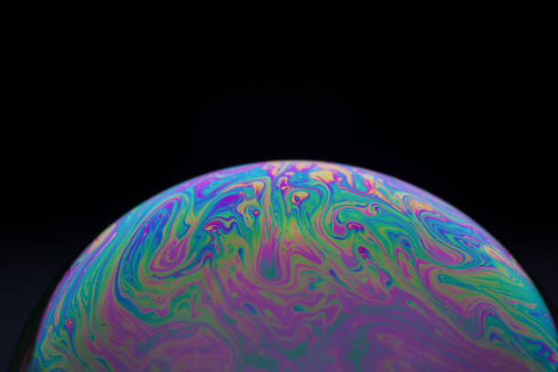 istock Half a soap bubble. Close-up. Black background. Bright colors. Side view. Imitation of an unknown planet. Science fiction 1401602636