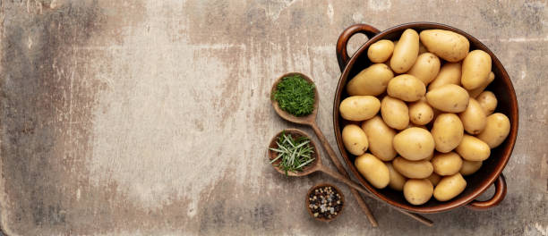 istock Raw small potatoes in a cast iron skillet on a beton background. 1401603842