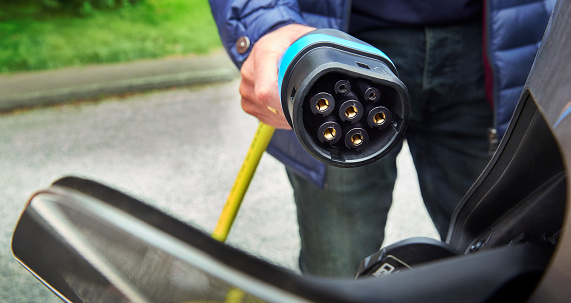 Charging an electric car at an electric vehicle charging station