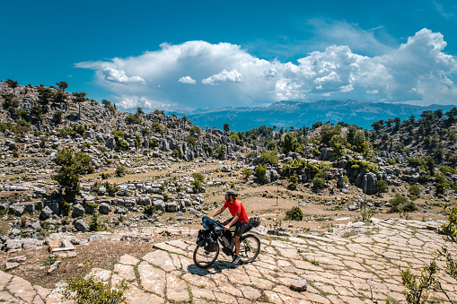 Mediterranean region bikepacking system bike in background different rock shapes mountain range.Nature landscape cloud aerial