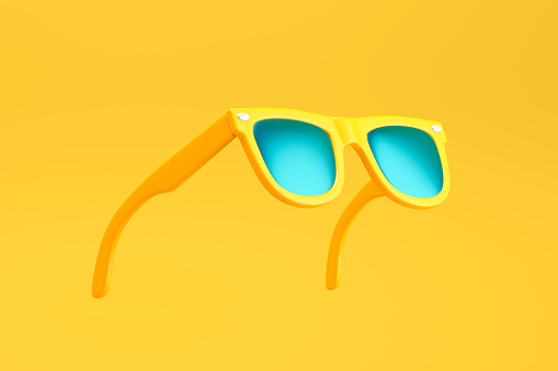 Yellow sunglasses on yellow background