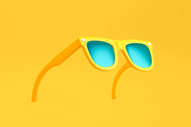 Yellow sunglasses on yellow background stock photo