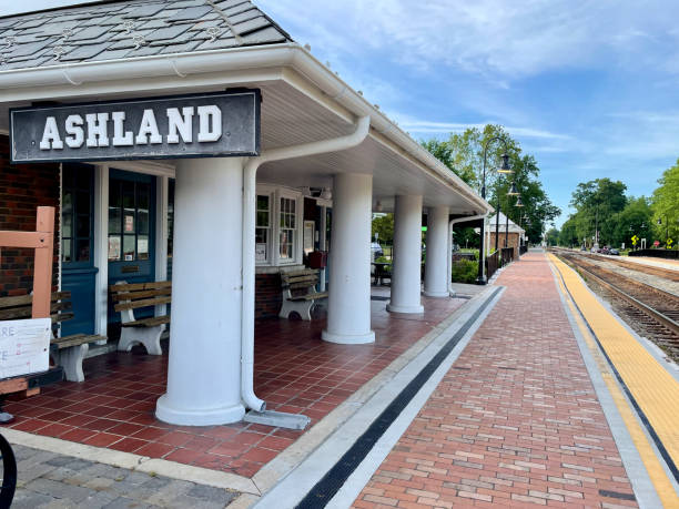 Ashland, Virginia, USA - June 5, 2022: Recently renovated boarding platforms at the historic Amtrak train station await passengers and trains alongside dual rail tracks that run through downtown Ashland on a quiet Sunday afternoon.