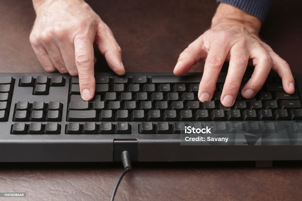 Keyboard Man is typing on keyboard Key Stock Photo
