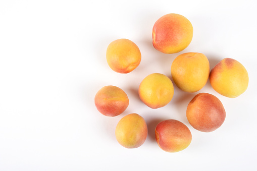 Directly above fresh apricots on the white background with copy space