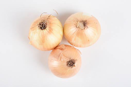Directly above onions on the white background