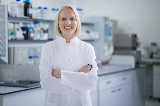 istock Happy female scientist standing in her laboratory 1401611629